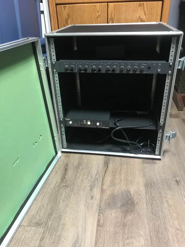 Black and silver metal flight case, closed, with multiple latches visible.