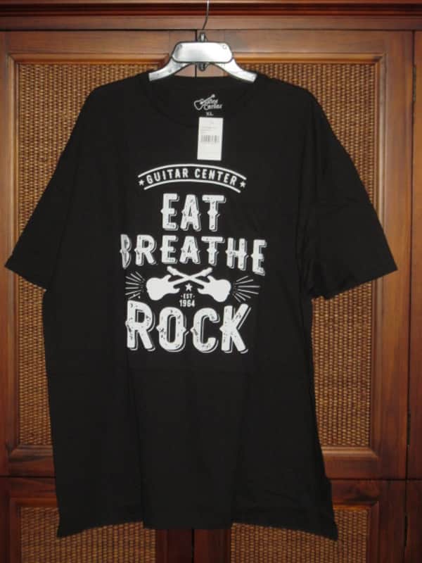 new in package A+ Guitar Center EAT BREATHE, ROCK Men's Size X-Large (XL), Black 100% Cotton Short Sleeve T-Shirt - Graphic is in White and it says / shows: GUITAR CENTER EST. 1964, EAT, BREATHE, ROCK + has dual guitars, stars, lines (Style # GC005-11730) image 1