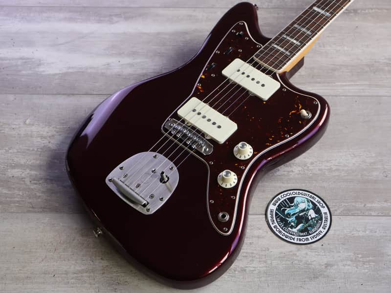 Orange Fender Telecaster electric guitar, visible bridge and controls.