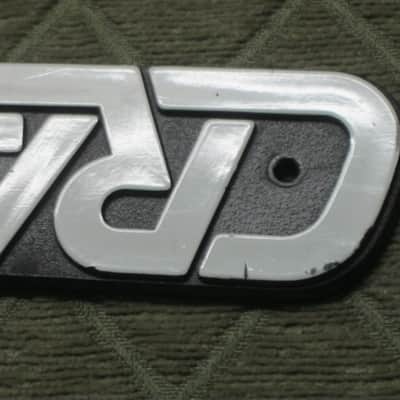 used - some imperfections genuine Crate bass amp Crate LOGO Plate (badge)- hard plastic - with 2 original screws (from a BX15 or BX25 bass amp - NO bass amp included) 1990s - early 2000s - Hard Plastic, white & black image 18