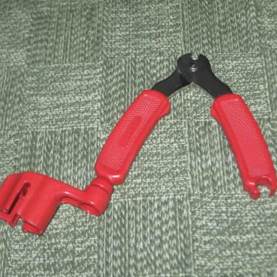 new old stock open package A+ D'Addario / Planet Waves 1st ver Pro-Winder RED String Winder & Cutter & Bridge PIn Puller, has different handle design than current DP0002 model,  from 2000s - for guitars, banjos, ukuleles, and mandolins image 4