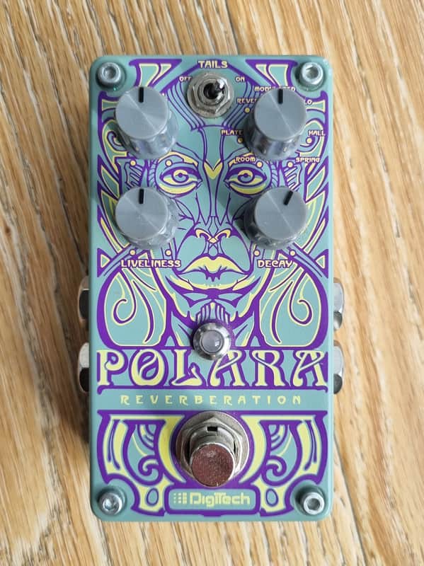 Colorful, psychedelic guitar effects pedal in a protective case.