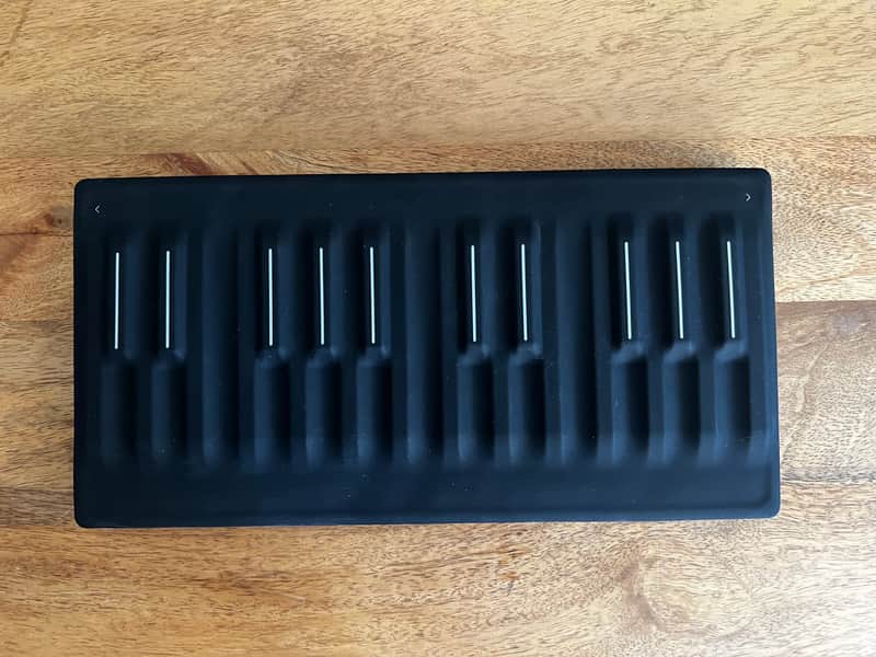 Black plastic display case with multiple slots for holding collectibles.