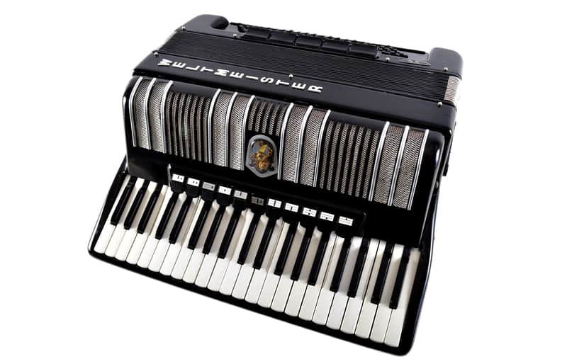 Black and silver accordion with white "Petrof" logo visible.