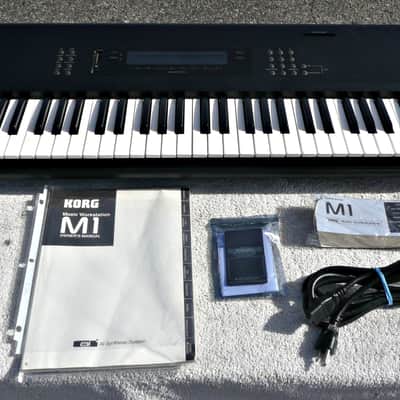 Korg M1 61 Key Synthesizer w​Original Manual Pocket Guide Book​ Korg M1 Ram Card + Power Cable​ - PV MUSIC Inspected and Tested​ - Powers Up + Retains Sounds But Has ​Damaged ​Motherboard ​KLM-1266​ - AS IS For ​Parts or ​Repair