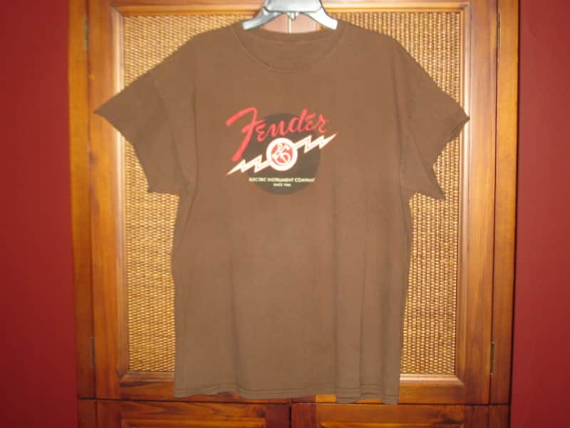 pre-owned genuine Fender Lightning Bolt Logo Short Sleeve, Cotton T-Shirt, XL, Brown (sleeves cut shorter) PN: 9101008621, from 2010, GRAPHIC: Red, Creme, Dark Brown, Fender, Ligntning Bolt, Circles, musical symbols, Electric Instrument Company Since 1946 image 1