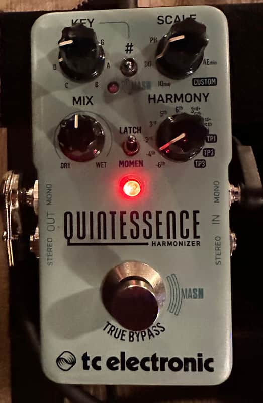 White and black guitar effects pedal with knobs and "Quintessence" branding.