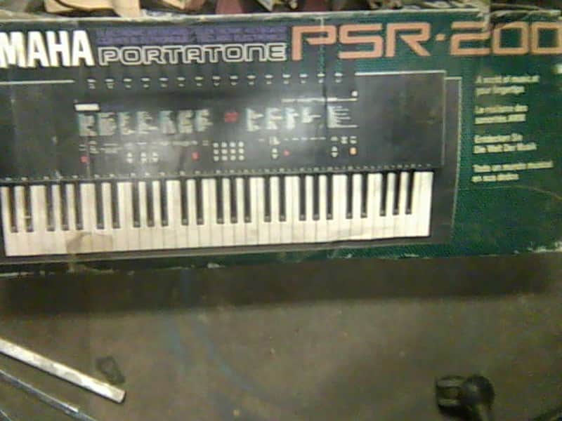 Yamaha psr-200 black plus a stack of learning keyboard books image 1