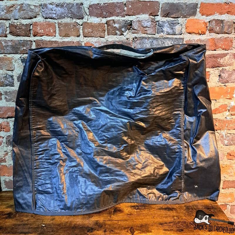 Brown suede guitar case with a rectangular patch pocket on the front.