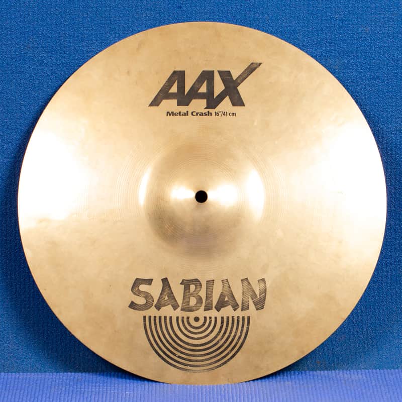 Gold cymbal with "AAX" logo visible on the surface.