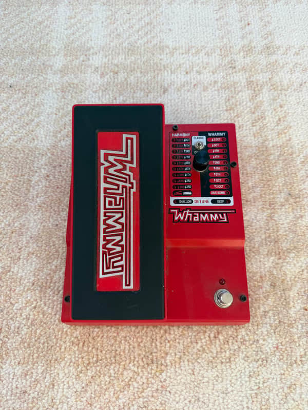 Red Whammy pedal with black case, showing harmony and whammy controls.