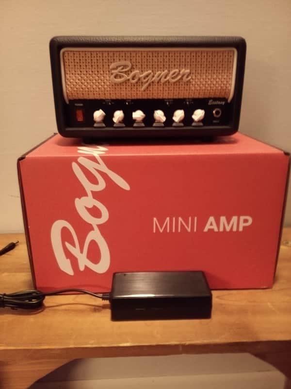 Orange box with "MINI AMP" above a small, brown Bogner amplifier.