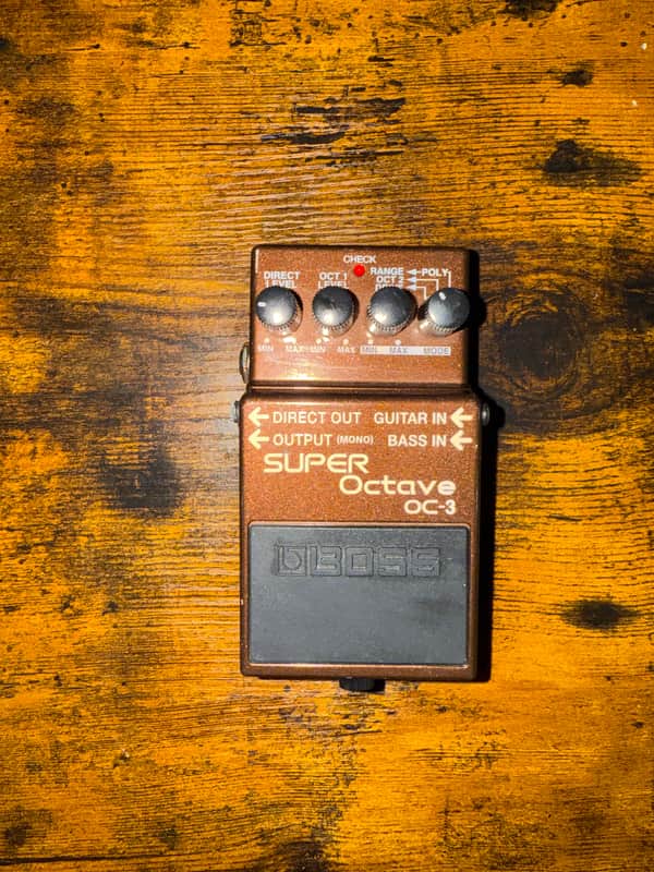 Black Boss Super Octave OC-3 guitar effects pedal on clear stand.