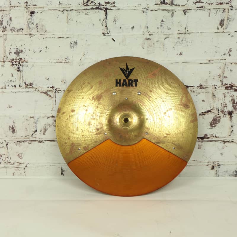Gold and orange circular metal object with "HART" logo in center.