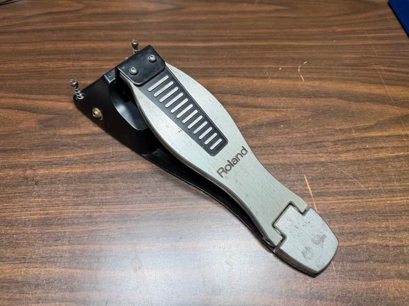 Silver and black Roland guitar strap, metal hardware, appears in good condition.