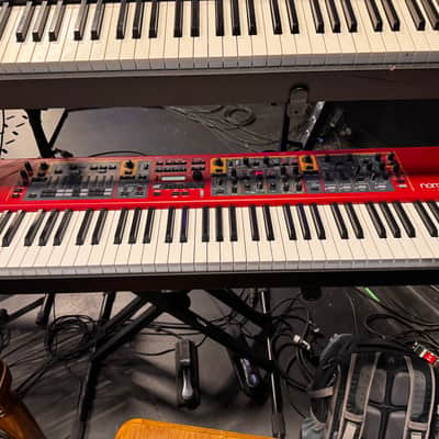 Nord Stage 2 Ex 88 2015-2017 - signature red painted chassis paired with distinct, exposed wooden side panels (cheeks) that give it a premium, classic-meets-modern aesthetic. image 1