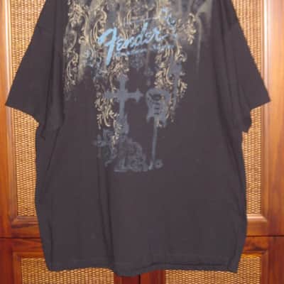 new old stock genuine Fender Heaven's Gate Custom Shop 100% Cotton Black Short Sleeve T-Shirt, XXL (XX-Large) (part #): 9101040806, early 2010s, GRAPHIC: Tan, Blue, Brown, Black (cross, 2 guitars, floral swirl, Fender, Custom Shop) NO: hang tag/packaging image 2