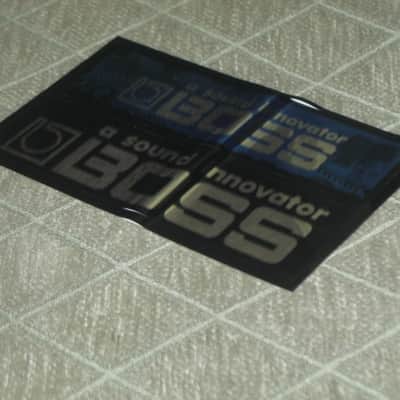 never used genuine BOSS sticker sheet (1 sheet has 2 stickers) 1) BOSS a sound innovator - colors Silver, Blue, Black Silver & 2) BOSS a sound innovator - colors Silver & Black (specifically from 1988), was orig paired w/ a DC3 Japan (pedal NOT included) image 3