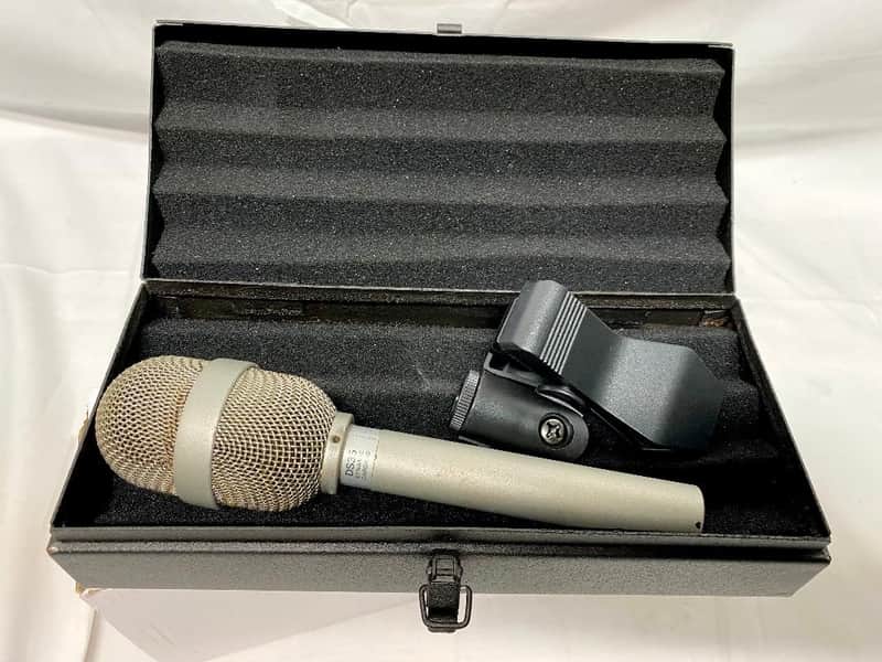 Vintage silver and black microphone with visible wear and patina.