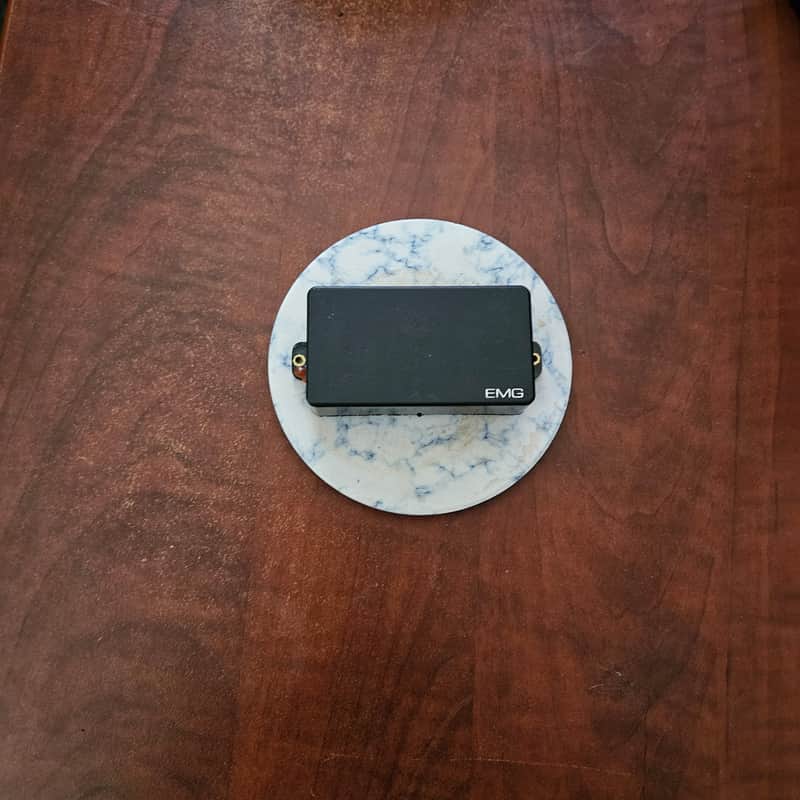 Black EMG guitar pickup box, rectangular, simple design.