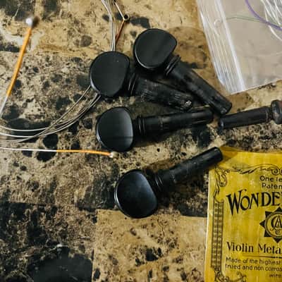 Violin fittings; bridges chin-rest, various brands of strings new and old. Project for luthier, pegs and other fittings. Sold as is. image 7