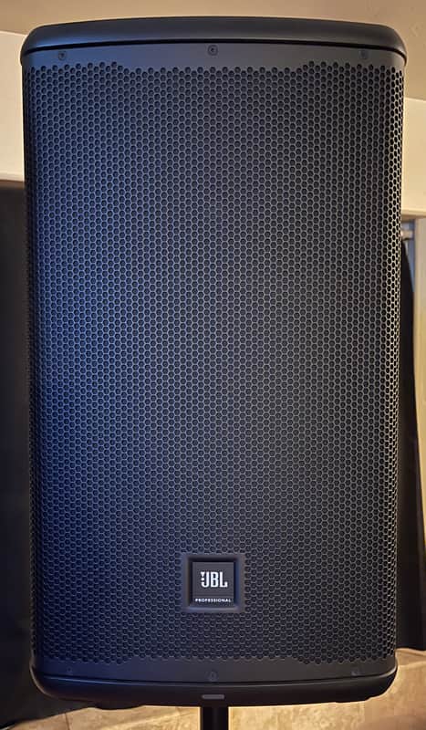 Black speaker on stand, grille visible, JBL logo on front.