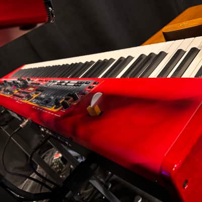 Nord Stage 2 Ex 88 2015-2017 - signature red painted chassis paired with distinct, exposed wooden side panels (cheeks) that give it a premium, classic-meets-modern aesthetic. image 5