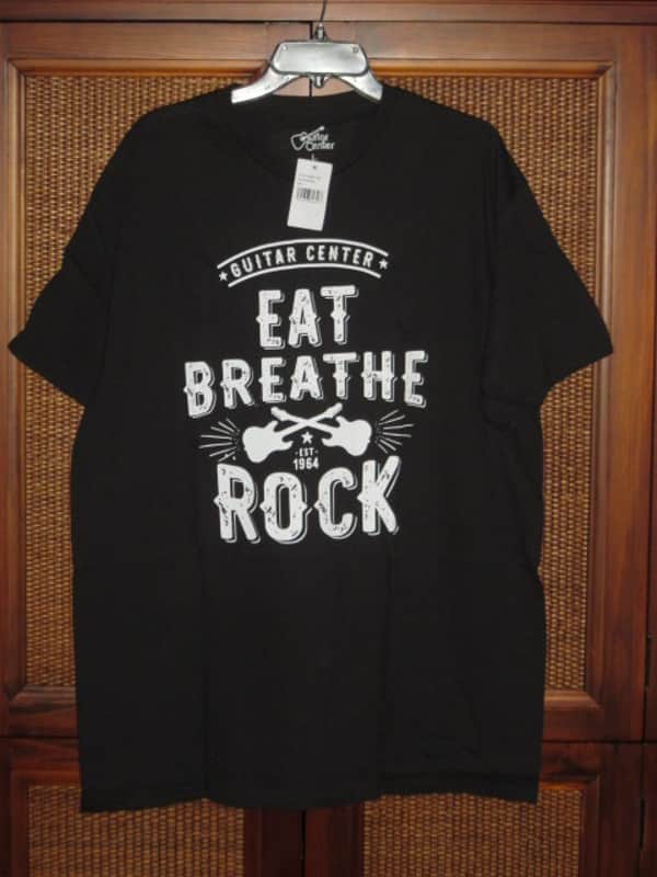 new in package A+ Guitar Center EAT BREATHE, ROCK Men's Size Large (L), Black 100% Cotton Short Sleeve T-Shirt - Graphic is in White and it says / shows: GUITAR CENTER EST. 1964, EAT, BREATHE, ROCK + has dual guitars, stars, & lines (Style # GC005-11730) image 1