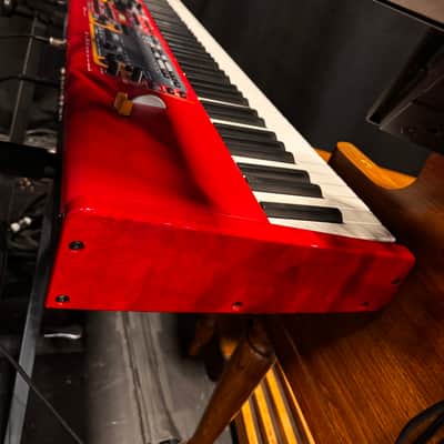 Nord Stage 2 Ex 88 2015-2017 - signature red painted chassis paired with distinct, exposed wooden side panels (cheeks) that give it a premium, classic-meets-modern aesthetic. image 2