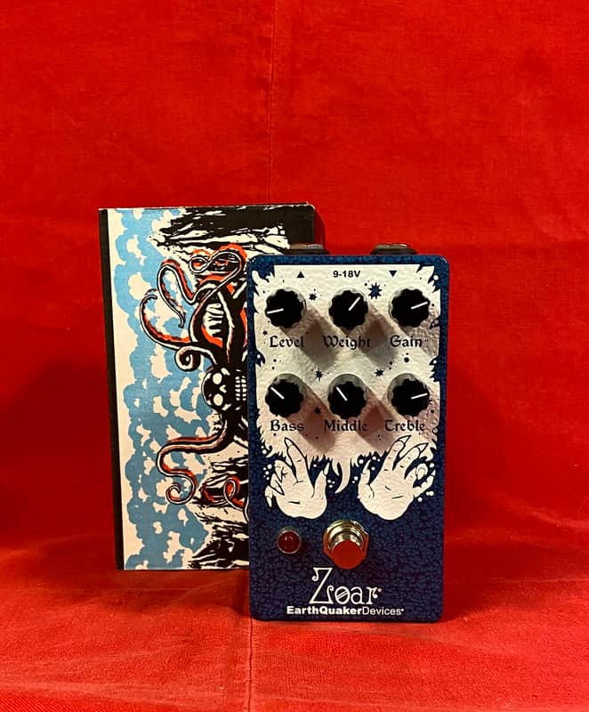 Blue and black guitar effects pedal next to a blue box with octopus design.