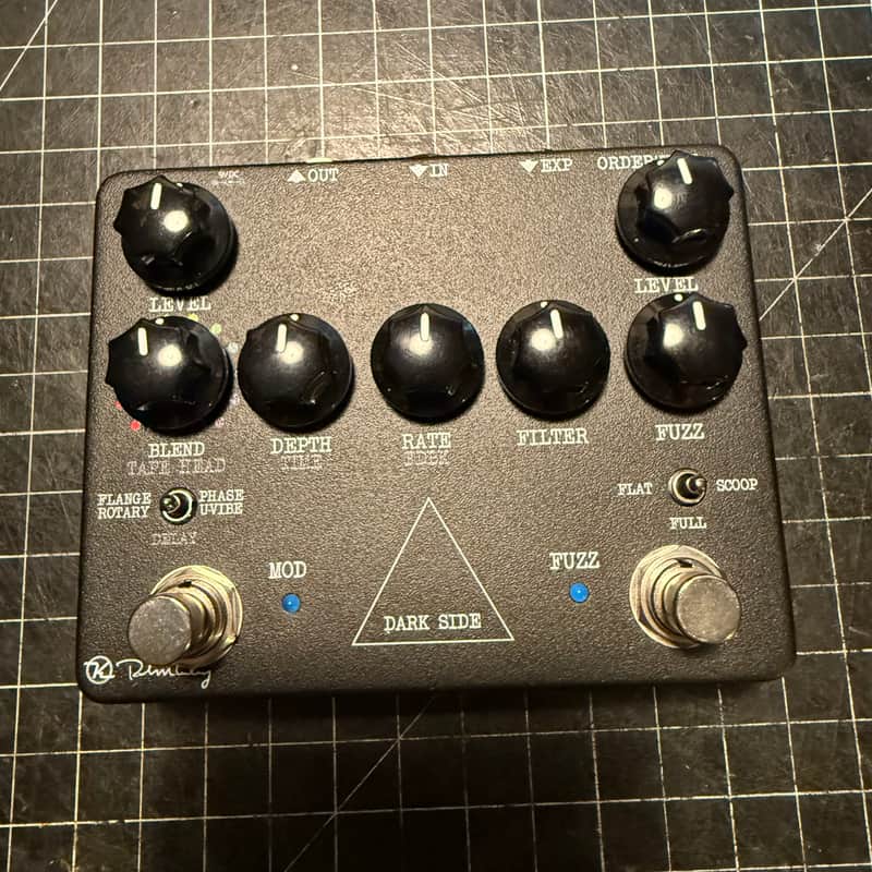 Black Dark Side guitar effects pedal with knobs, next to its white box.