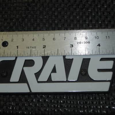 used - some imperfections genuine Crate bass amp Crate LOGO Plate (badge)- hard plastic - with 2 original screws (from a BX15 or BX25 bass amp - NO bass amp included) 1990s - early 2000s - Hard Plastic, white & black image 3
