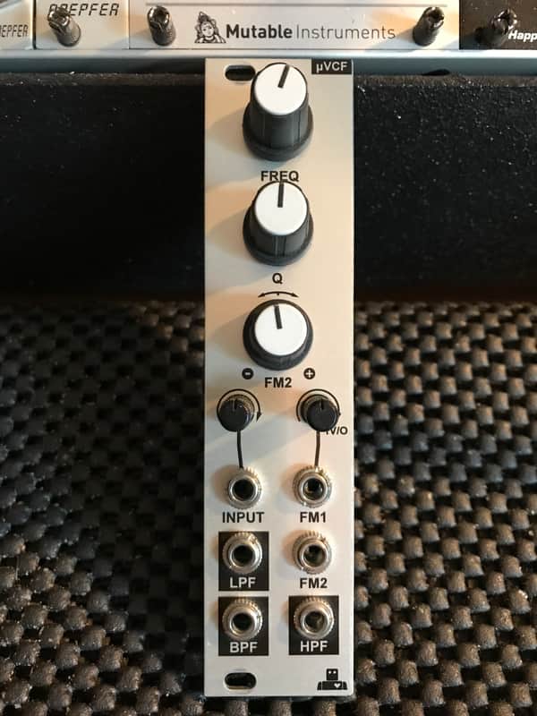 Silver and black vintage audio equalizer with knobs and jacks.