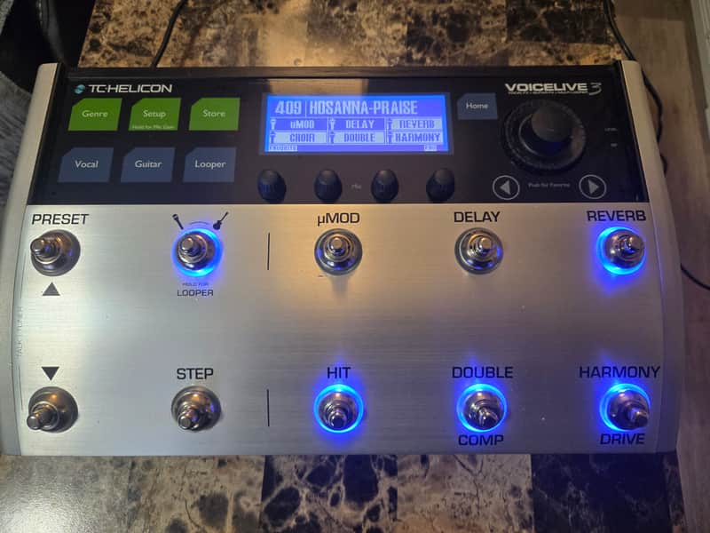 Black and silver digital effects pedal with multiple knobs and buttons.