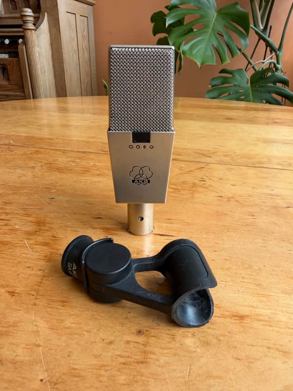 Gold AKG microphone with black base, showing model number Q08Q.