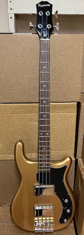 Red electric guitar resting on red upholstered surface.