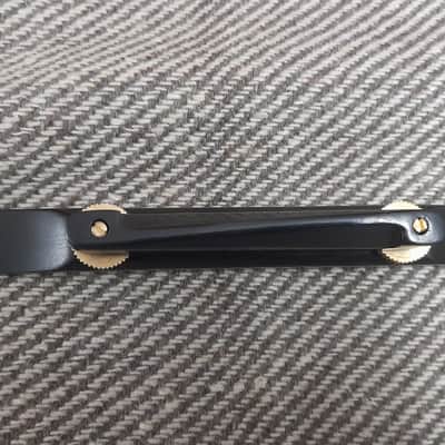 Plain Archtop Guitar Bridge -1 pc in Ebonywood with Golden wheels image 2