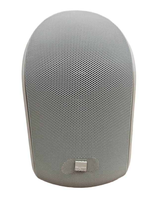Silver, rounded, mesh-covered portable Bluetooth speaker.