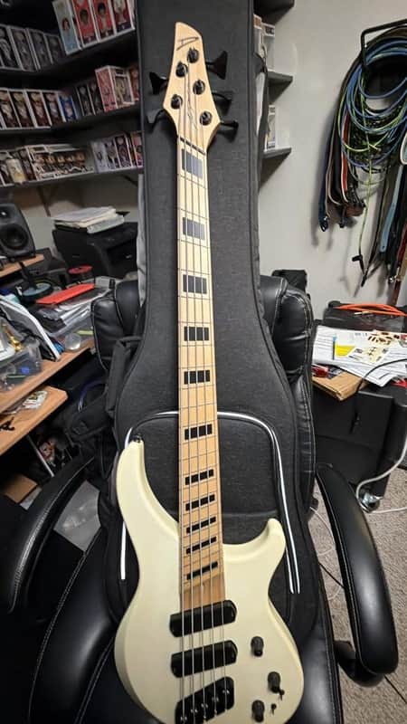 Red electric bass guitar on black cloth. Chrome hardware visible.