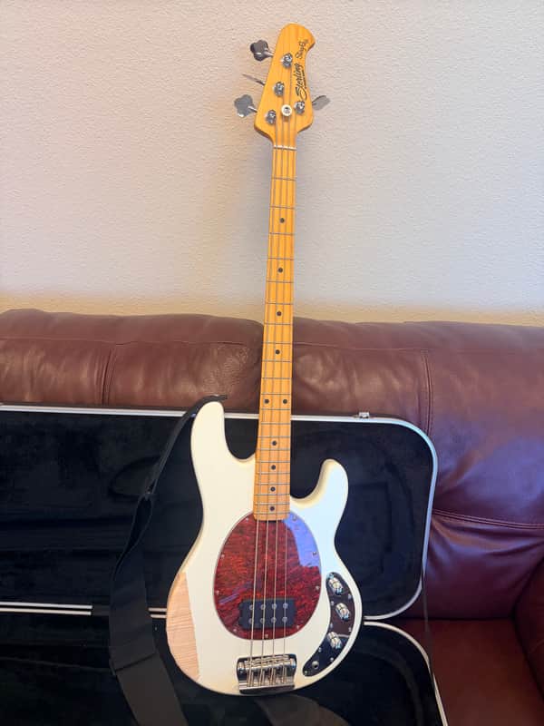 Light blue electric guitar on black stand, visible headstock and body.