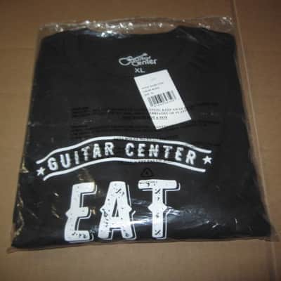 new in package A+ Guitar Center EAT BREATHE, ROCK Men's Size X-Large (XL), Black 100% Cotton Short Sleeve T-Shirt - Graphic is in White and it says / shows: GUITAR CENTER EST. 1964, EAT, BREATHE, ROCK + has dual guitars, stars, lines (Style # GC005-11730) image 14