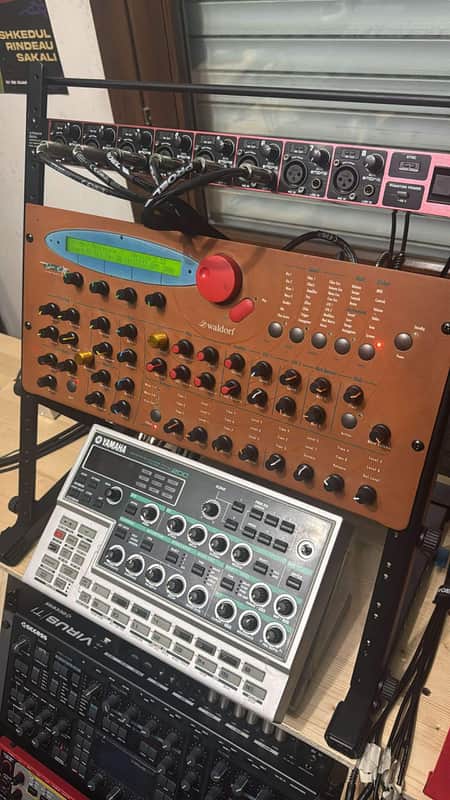 Waldorf synthesizer keyboard, brown and tan, with various knobs and buttons.