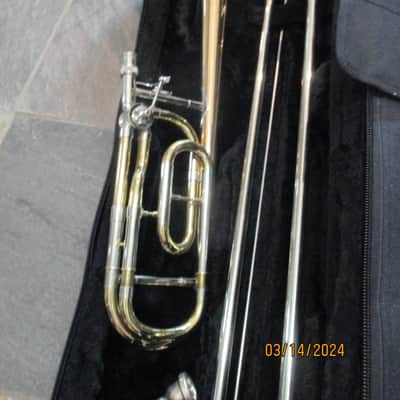 New Gold color trigger trombone. With case and mouthpiece. image 1