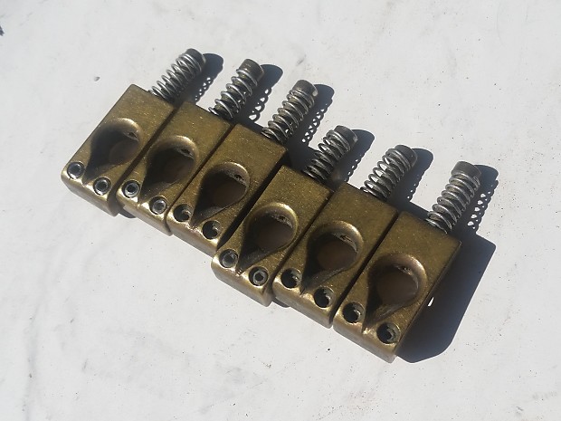 charvel(?) keyhole 1st gen brass bridge saddles for strat etc. 1978-79 brass