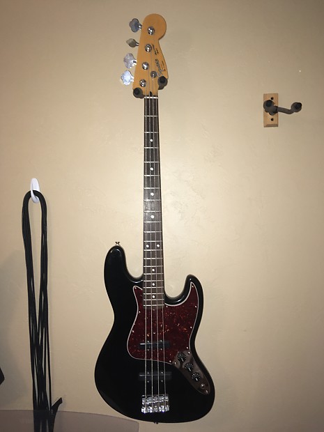 Black jazz bass with tortoise pickguard top