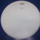 Remo Ambassador White Coated Batter 18" drum head has small ding, and a scuff