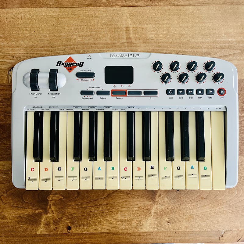 Small MIDI Controller Piano on Yellow Background with Cell Phone