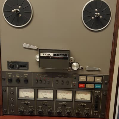 Four New/Old Stock quarter inch reel to reel tapes, a used quarter inch reel  to reel tape, a Teac reel to reel spool and Boss and a Sony HE-2 head  demagnetiser