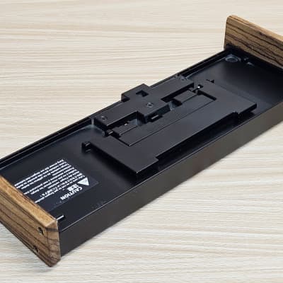 Roland DK-01 Black Boutique Dock with Wood Side Panels for use with JX-08, TB-03, TR-06, TR-08, SH-01A, TR-09, VP-03, A-01, JP-08, JX-03, JU-06, JU-06A, D-05 synthesizers