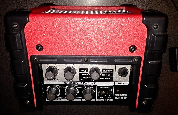 Red roland micro cube amp compact runs on batteries or power